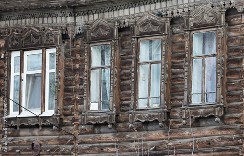 Carved wooden trim facade. Old historic house. Russian architecture. Chopped house with carved wooden architraves. Tomsk  Russia