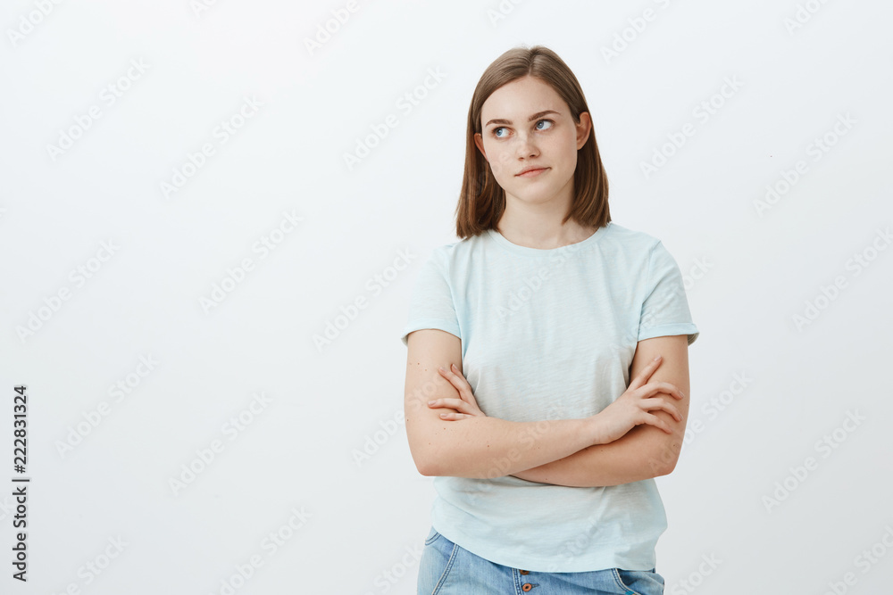 Cute girl bothered with unpopular clingy guy trying ask her out looking irritated and annoyed left crossing hands on chest and pursing lips being indifferent and uninterested posing over white wall Cute girl bothered with unpopular clingy guy trying ask her out looking irritated and annoyed left crossing hands on chest and pursing lips being indifferent and uninterested posing over white wall