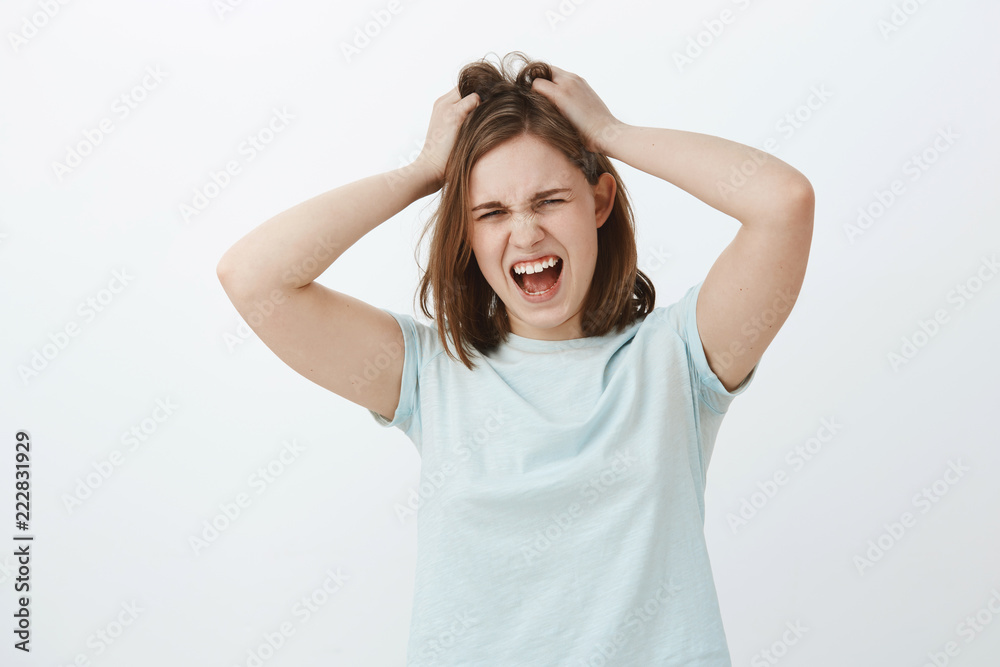 Girl hates think too much. Displeased distressed young upset european woman with brown short haircut screaming while losing temper being angry or mad messing up or pulling hair out of head Girl hates think too much. Displeased distressed young upset european woman with brown short haircut screaming while losing temper being angry or mad messing up or pulling hair out of head