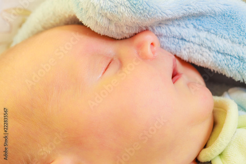 Little newborn baby sleeping calmly in blanket © Voyagerix