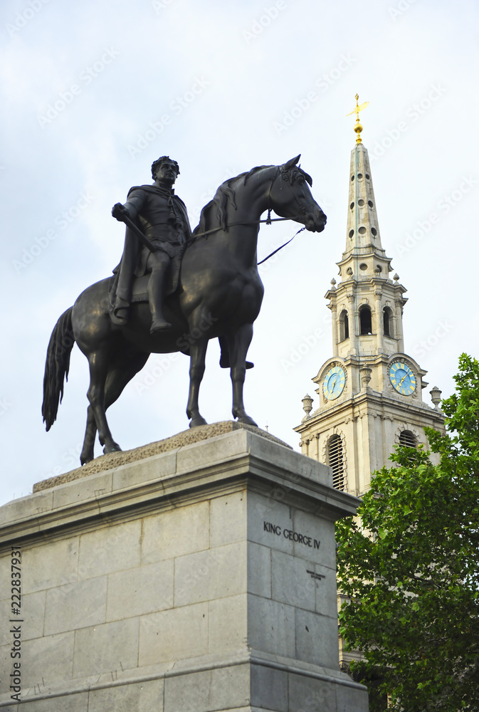 Equestrian statue of King George IV on Trafalgar Square with the St. Martin in the Fields church. London, UK 