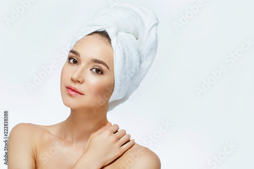 Beautiful woman in a white towel on a head.