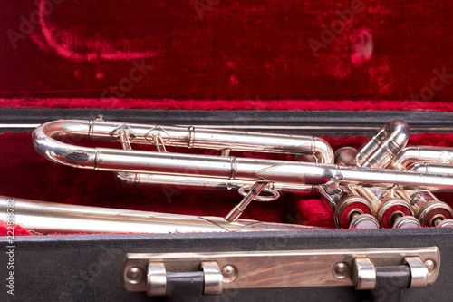 Close up old trumpet in velvet case. Vintage musical instrument in original case. Classical wind instrument. © DenisProduction.com