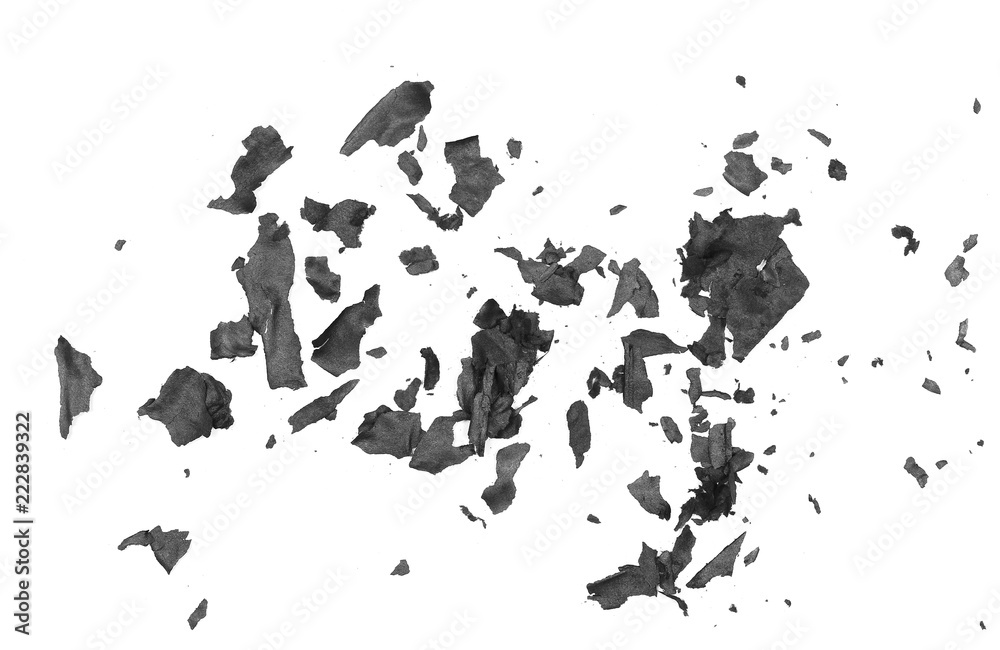 Obraz premium Burned, charred paper scraps isolated on white background, top view