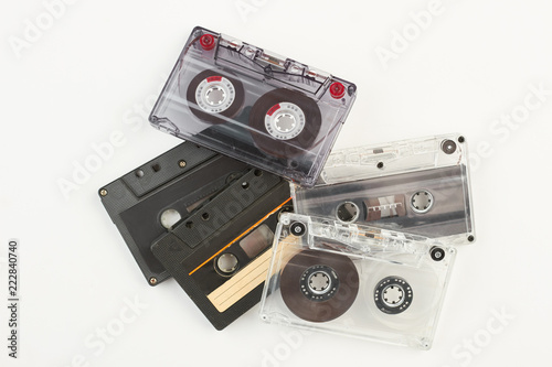 Pile of retro cassette tapes. Stack of old tape cassetes over white background. Music vintage device. photo