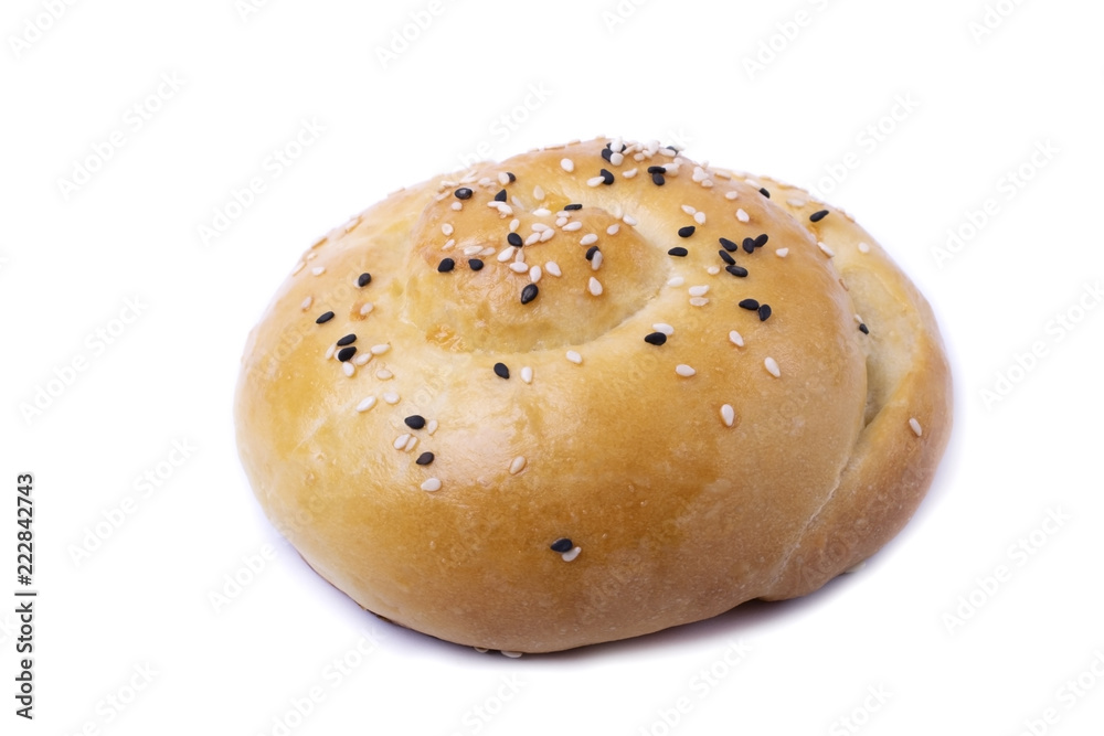 Yeast dough bun sprinkled with sesame seeds isolated on white Yeast dough bun sprinkled with sesame seeds isolated on white