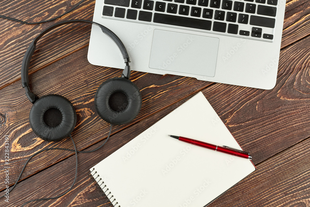 Laptop, headphones, notebook and pen. Working desk with laptop, blank paper  notepad, headphones and pen. Desk with office accessories. Entertainment or  work place. Stock Photo | Adobe Stock