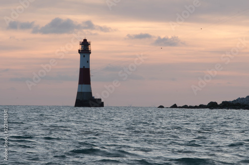 Beachy head lighthouse near Eastbourne in United Kingdom while red sunset behind the lighthouse. © Dimitar