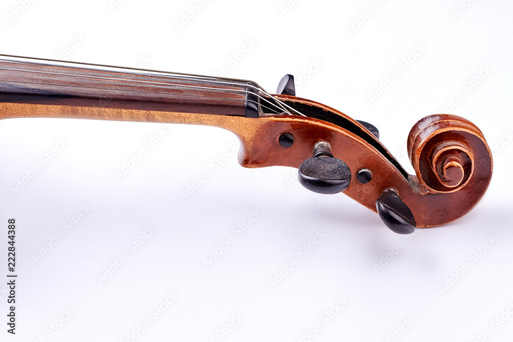 Fototapeta Scroll of the violin on white background. Head of vintage violin over white background. Construction of cello: scroll and peg box. Flat lay image.