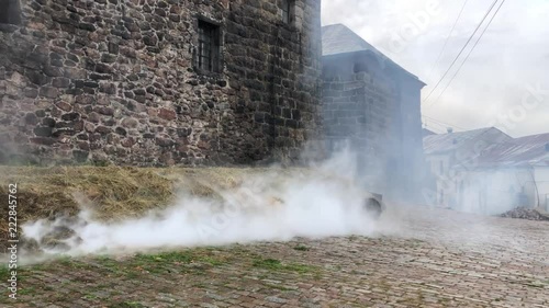 Smoke. Hay. Ancient castle walls. Vyborg. Russia.