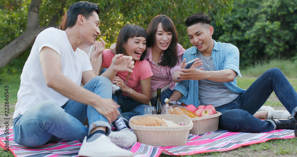 Youngster friends go picnic together at park Youngster friends go picnic together at park