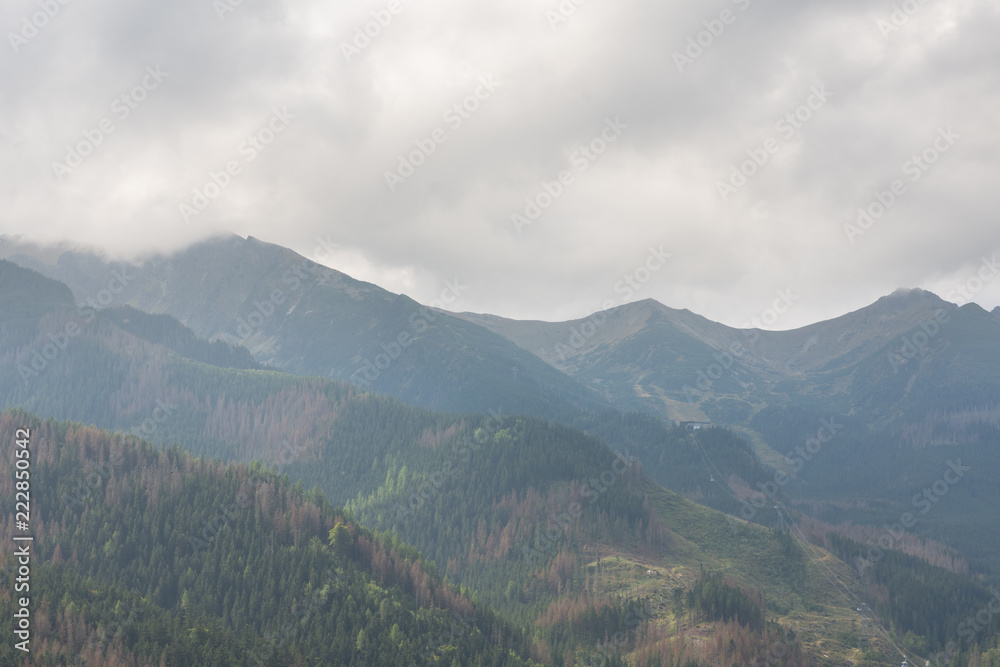 Mountains covered with fog during the day. Polish Tatras