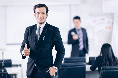 Successful Cooperation Organization Peoplel !Confident Business man show thumbs up in conference room.Meeting room for analyzing charts and graphs photo