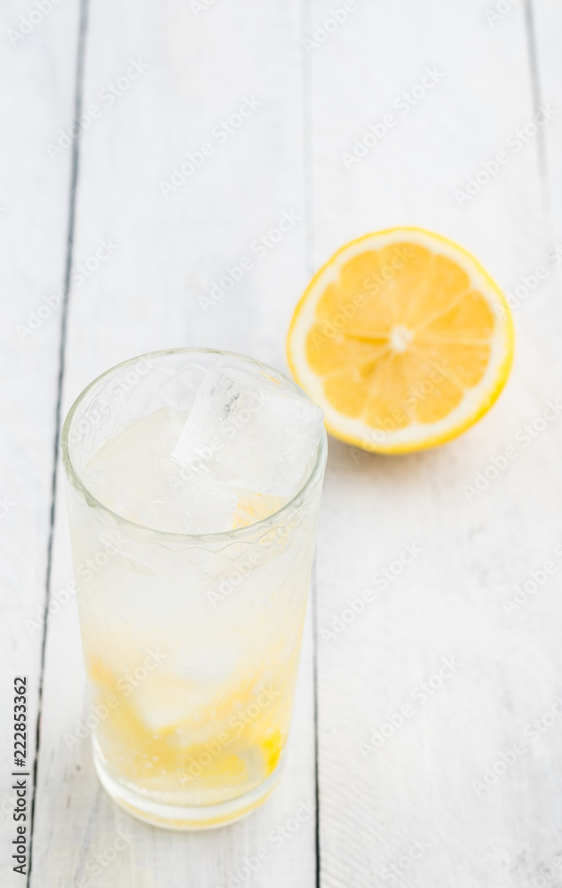 Lemon juice detox water. Mineral water infused with lemons. Wooden white table. Lemon juice detox water. Mineral water infused with lemons. Wooden white table.