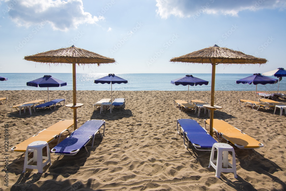 Umbrellas and sunbeds on Tsampika beach, Rhodes island, Greece