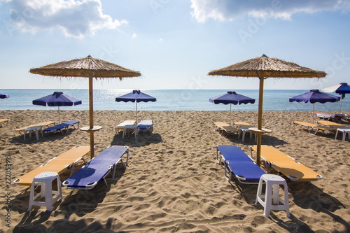 Umbrellas and sunbeds on Tsampika beach, Rhodes island, Greece © Mistervlad