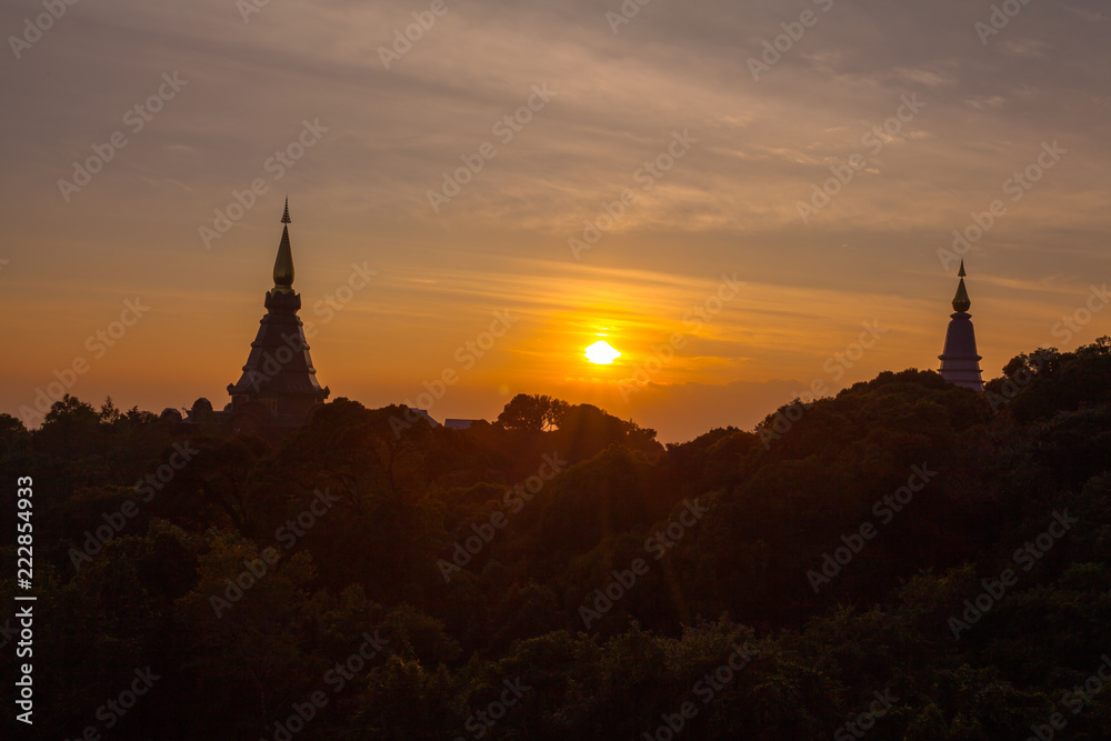 Obraz premium sunset between Noppamethanedol and Noppapol Phumsiri pagoda on Doi Inthanon national park..Doi Inthanon national park is the highest mountain of Thailand