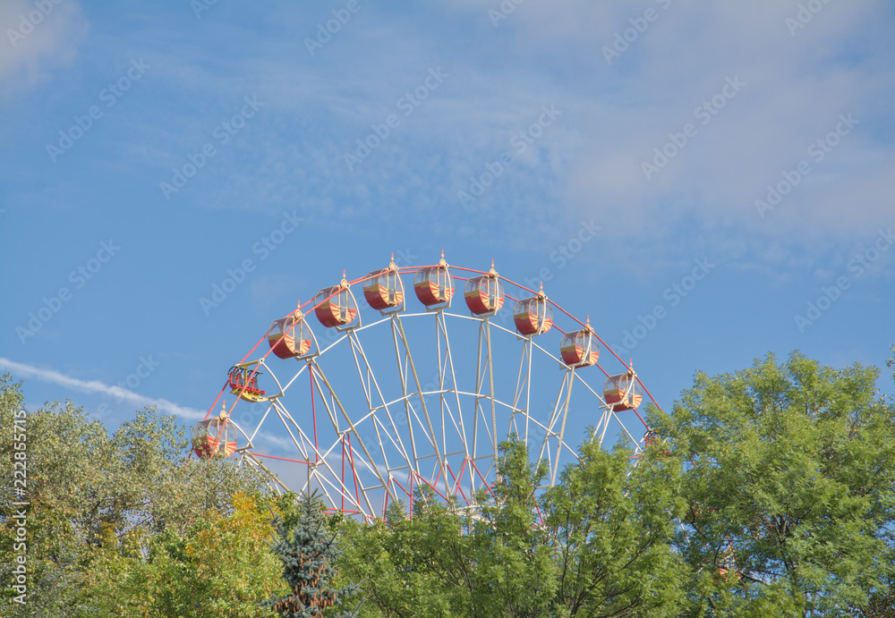 Ferris wheel on the background of blue sky Ferris wheel on the background of blue sky
