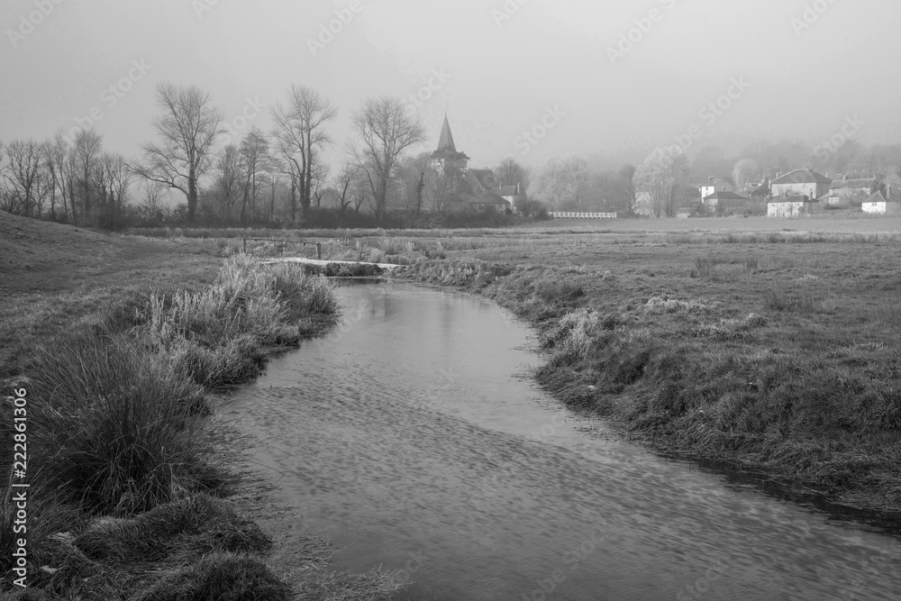 Cold misty Winter landscape over stream in English countryside black and  white image Stock Photo | Adobe Stock