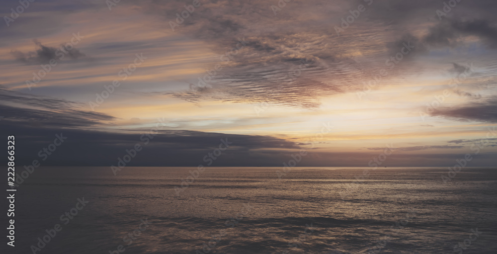 Sunlight sunset on horizon ocean on background seascape rays sunrise. Relax view waves sea on evening sand beach, sun light flare nature evening outdoor vacation concept, copy space for text.