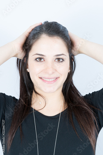 cute smiling pretty woman putting her hand in her hair