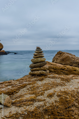 The photo of the stone on the beach on the long exposure