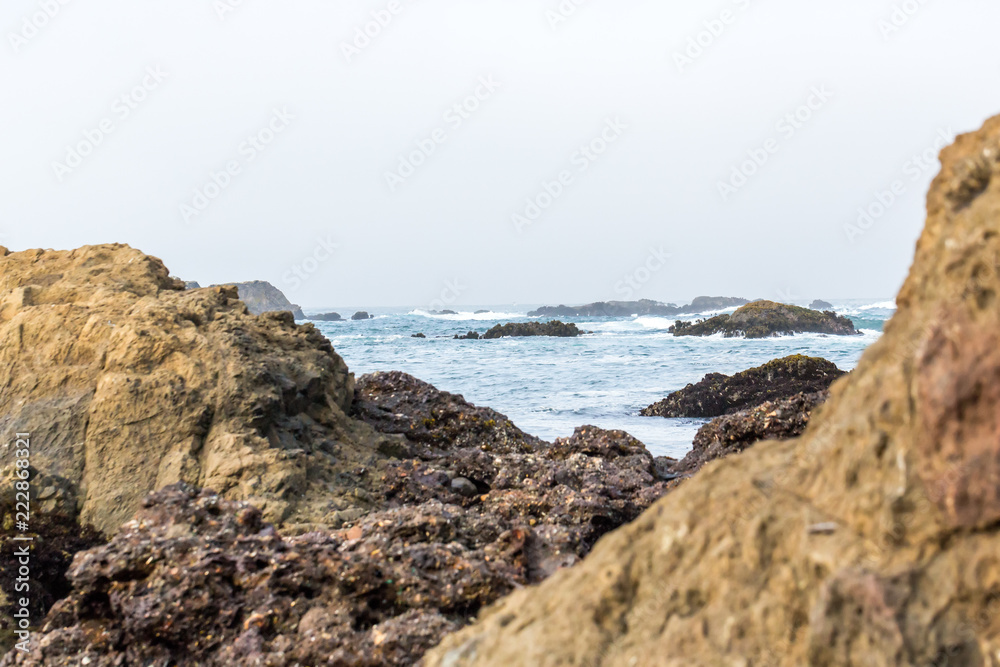 Piles of refuse forming reefs at glass beach