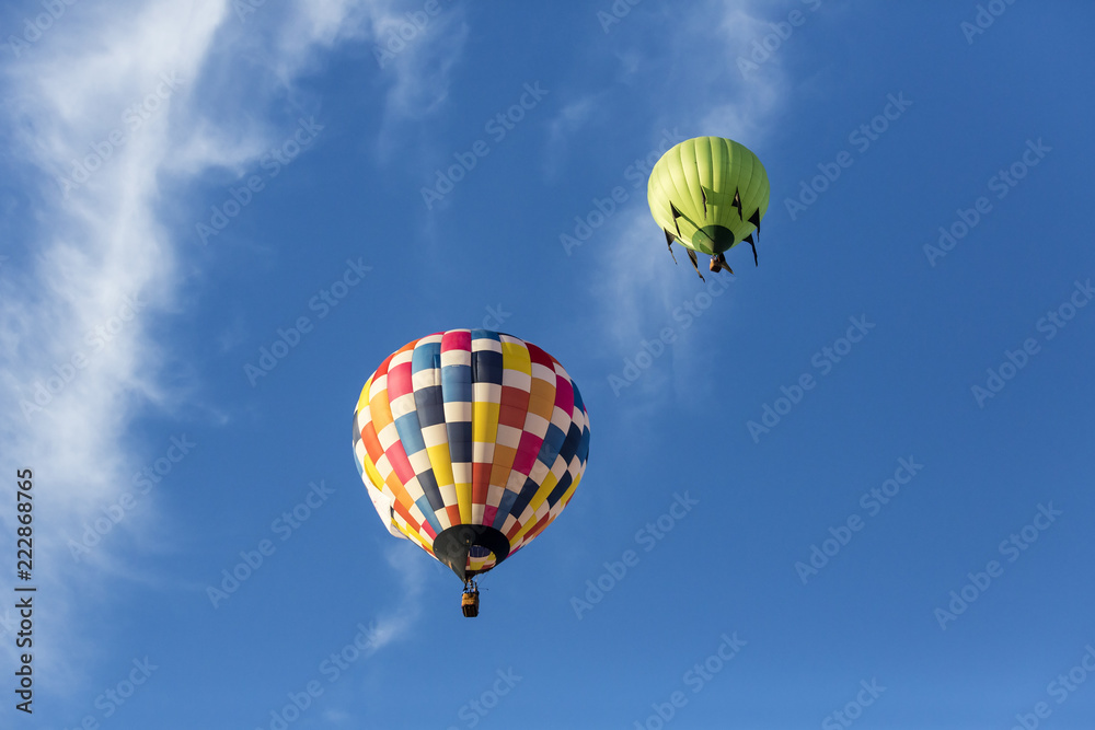 Hot air balloons flying in a beautiful blue clear sky Hot air balloons flying in a beautiful blue clear sky