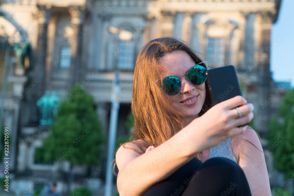 girl make selfie photo on smartphone in germany near berlin cathedral. modern life girl with smartphone. berlin cathedral destination place for tourists. i love selfie. capturing bright moments. girl make selfie photo on smartphone in germany near berlin cathedral. modern life girl with smartphone. berlin cathedral destination place for tourists. i love selfie. capturing bright moments.