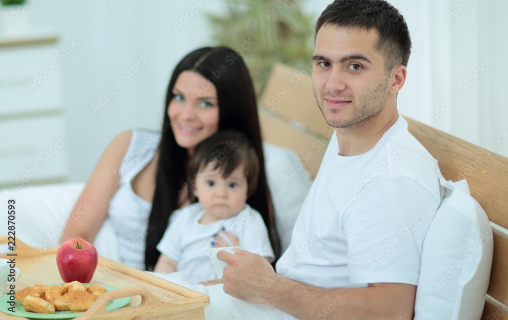 Family having breakfast in bed at home Family having breakfast in bed at home