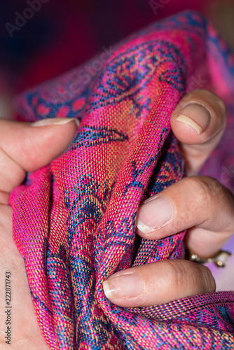 Hand holding tight a pink and purple original cashmere scarf