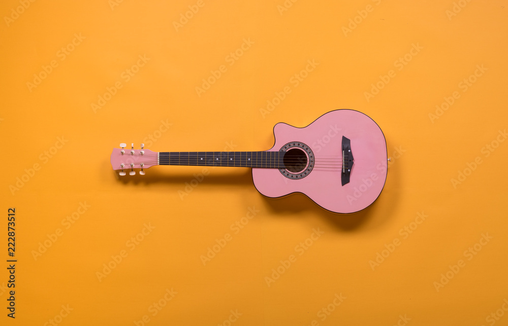 Fototapeta premium pink guitar on a yellow background