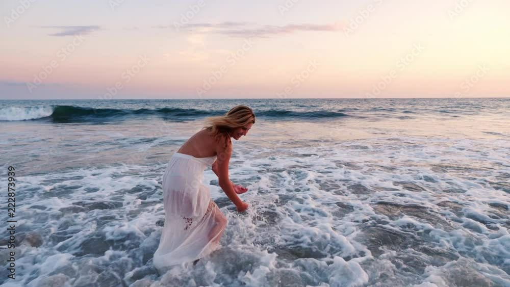 Attractive blond woman enjoying the beach at sunset. Attractive blond woman enjoying the beach at sunset.