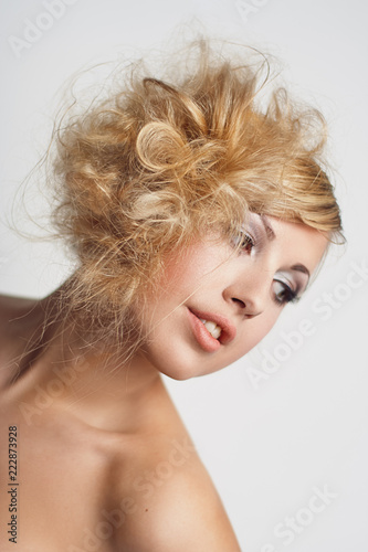 Portrait of a young woman with blond curly hair