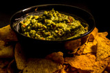 Guacamole in a bowl with nachos