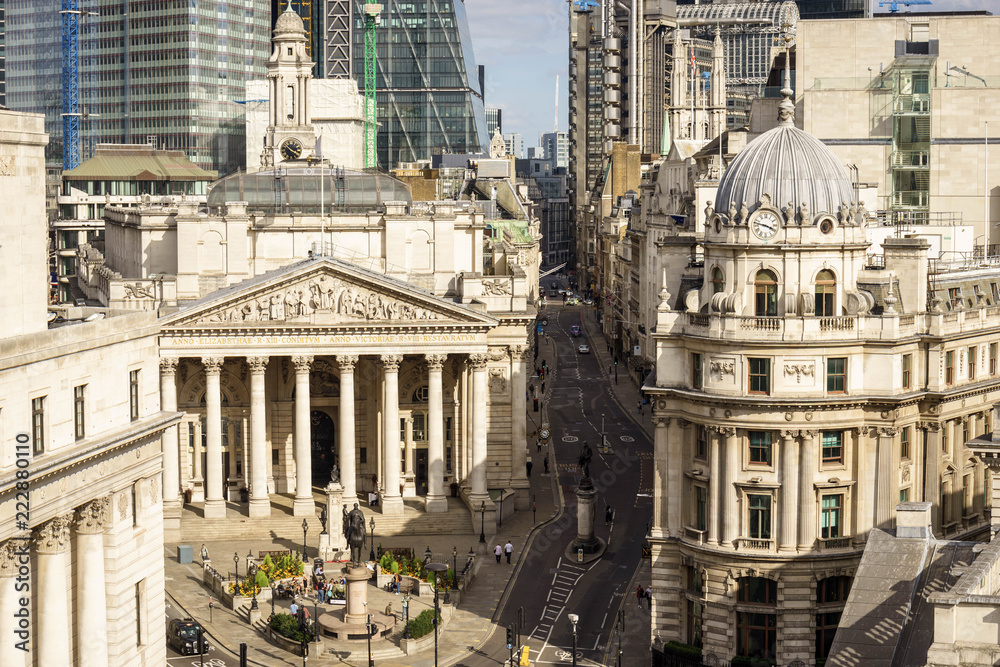 building of Royal Exchange in London near Bank underground station  and Aerial view of skyscrapers of the world famous bank district of central London on the background