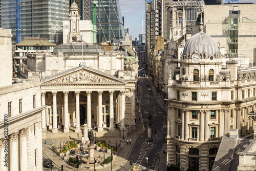 building of Royal Exchange in London near Bank underground station  and Aerial view of skyscrapers of the world famous bank district of central London on the background