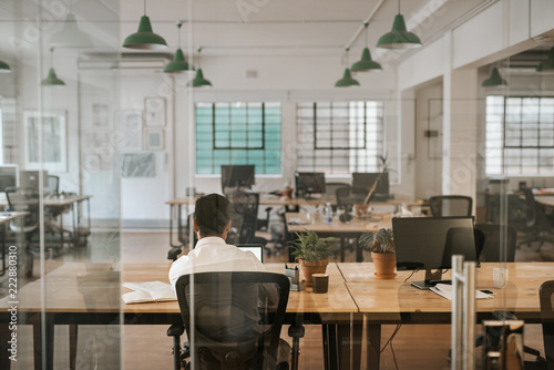 Fotografie Businessman working alone at a desk in an office
