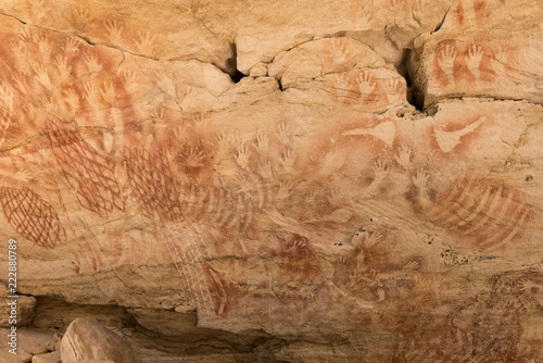 Aboriginal stencil rock art of hands, nets and stone axes at Cathedral Cave, Carnarvon Gorge, Queensland, Australia. photo