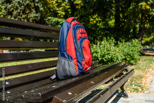 Tourist backpack on a bench in city park
