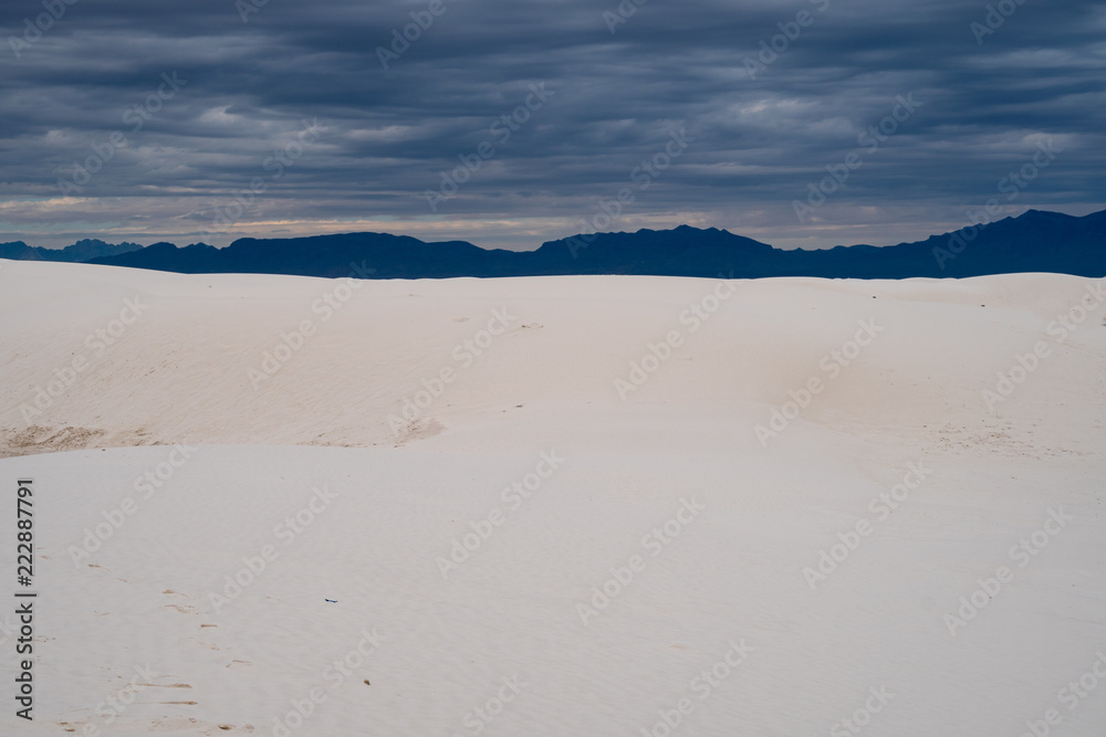White Sands National Monument on a cloudy, overcast stormy day. Stark contrast with white gypsum sand and dark clouds