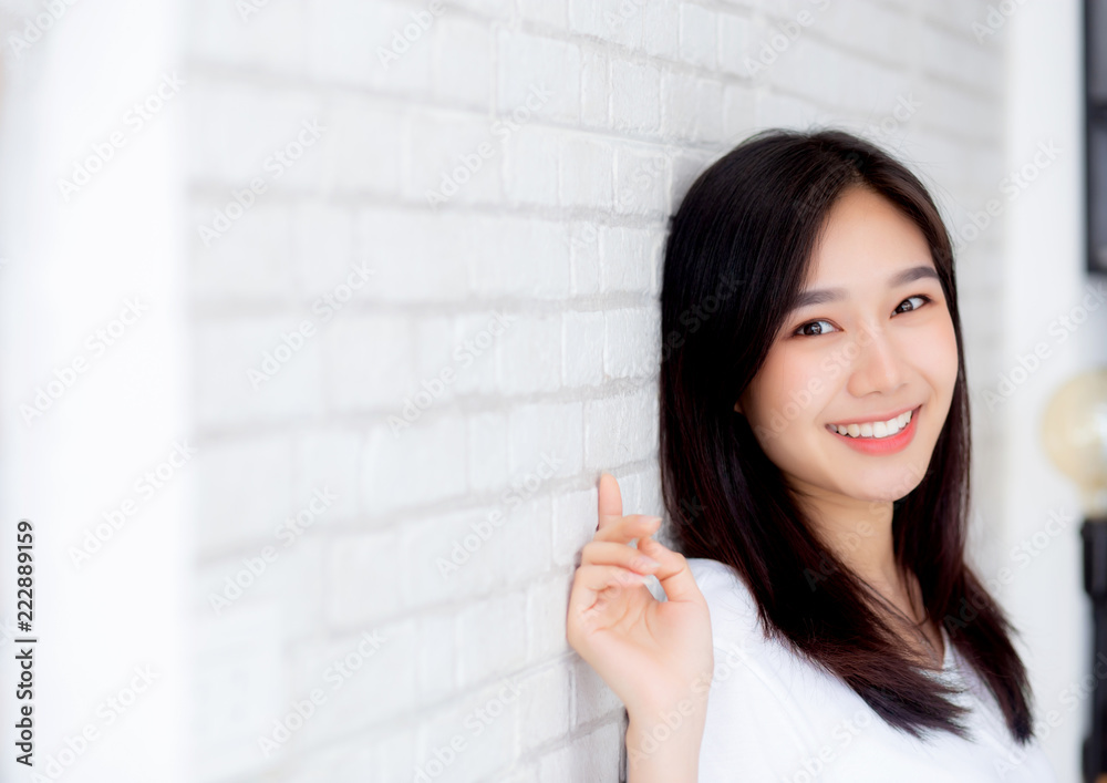 Portrait of beautiful young asian woman happiness standing on gray cement texture grunge wall brick background, businesswoman is a smiling on concrete, business people concept.