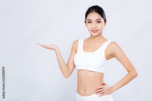 Portrait asian woman smiling beautiful body diet with fit presenting something empty copy space on hand isolated white background, model girl weight slim with cellulite, health and wellness concept.