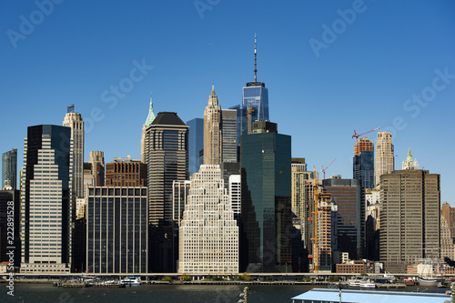 Amazing view of the Manhattan skyline seen from the Brooklyn Bridge Park. Sunny day of October in New York. USA.