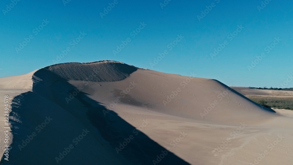 aerial picture a sand dune peak in a beautiful desert environment