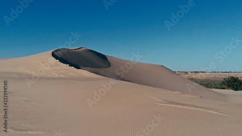 aerial picture a sand dune peak in a beautiful desert environment