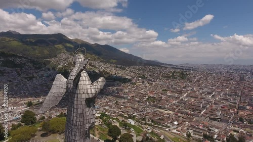 Flying behind the Statue of the Virgin overlooking Quito, Ecuador. Looking over the north of the city from the Panecillo with the Historic Centre in foreground.