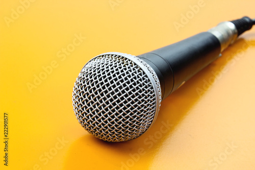 The microphone on the table wooden yellow.