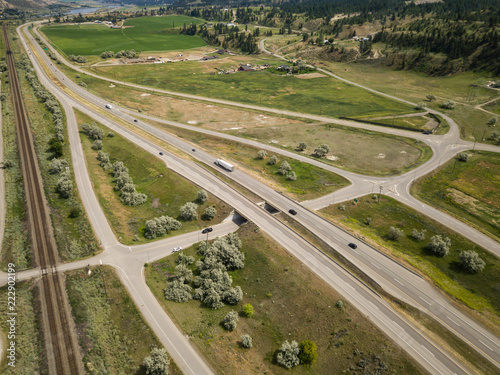 Aerial view of Trans-Canada Highway near Thompson River during a vibrant sunny summer day. Taken near Kamloops, BC, Canada.