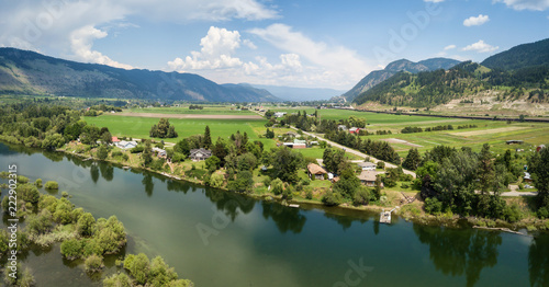 Aerial panoramic view of the Farm fields by Thompson River during a vibrant sunny summer day. Taken near Chase, BC, Canada.